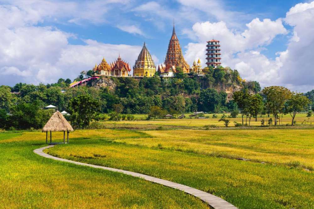 Le temple Wat Tham Suea vu depuis les champs au pied de la montagne